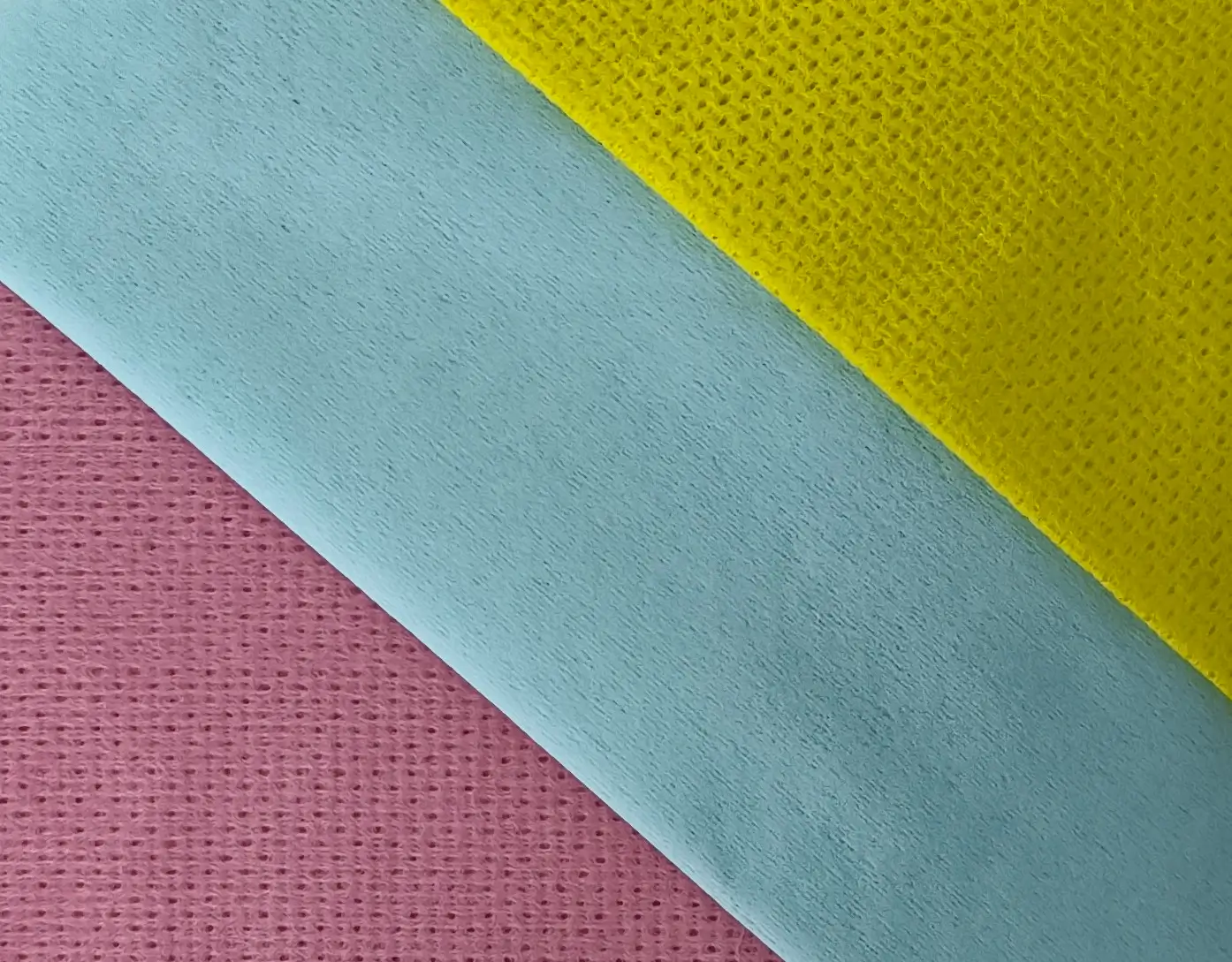 Close-up technical shot of a high-absorbency blue industrial cleaning cloth